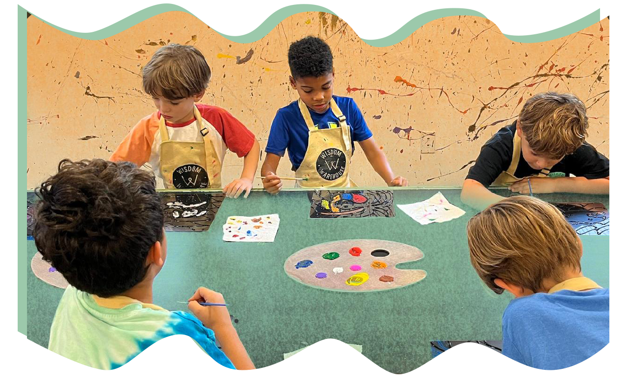 Students painting together around a table